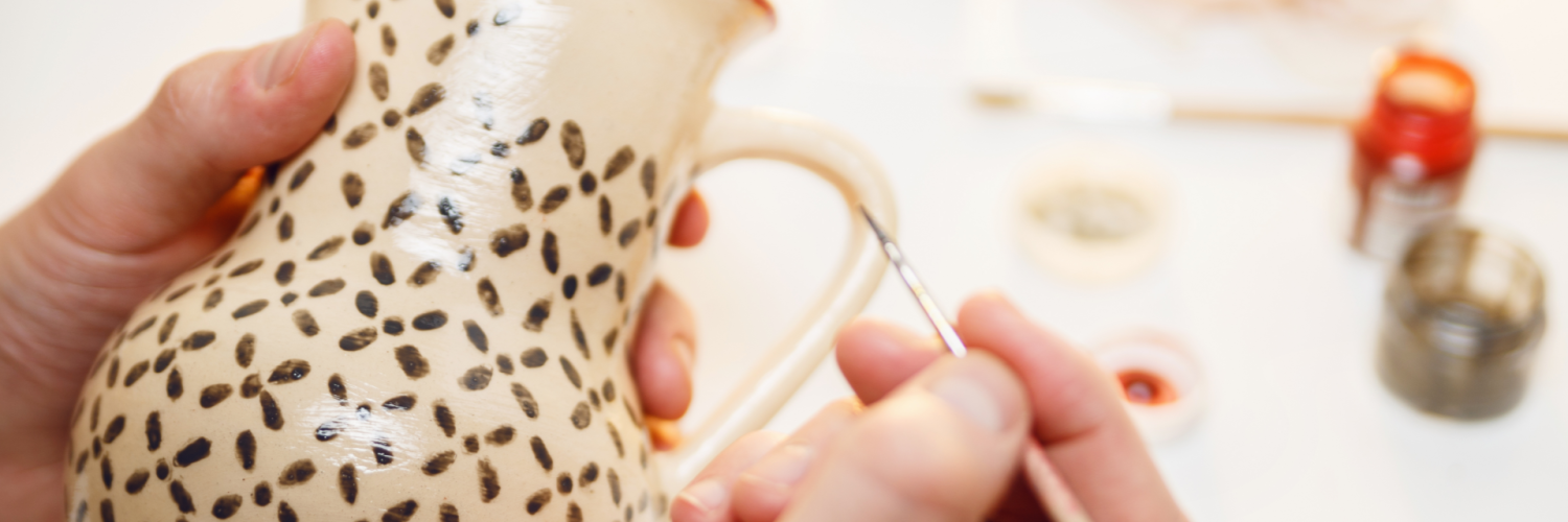 Artist painting pottery